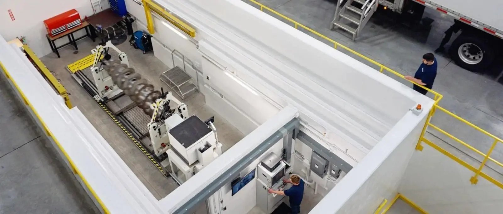 A decanter centrifuge scroll undergoes dynamic balancing inside a high-speed balancing bunker.